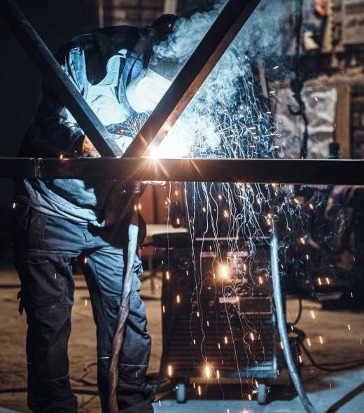 Welding work with metal construction at busy metal factory